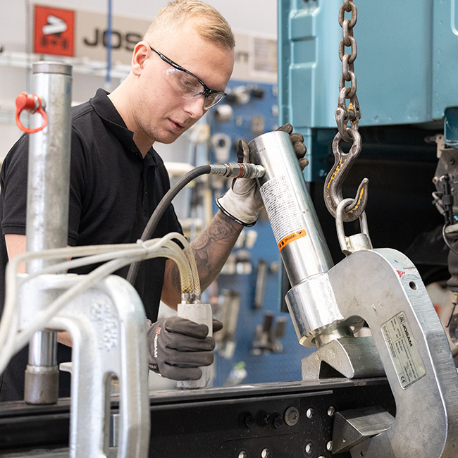 A technician using JOSAM hydraulic C-Clamp