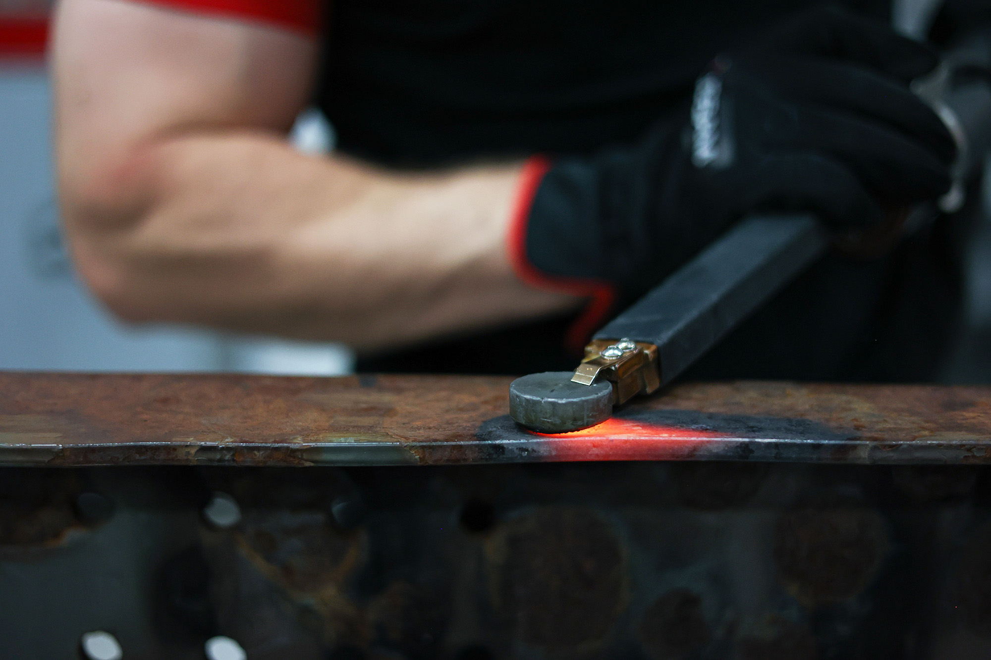 A technician using JOSAM JH1000 induction heater to heat metal surface