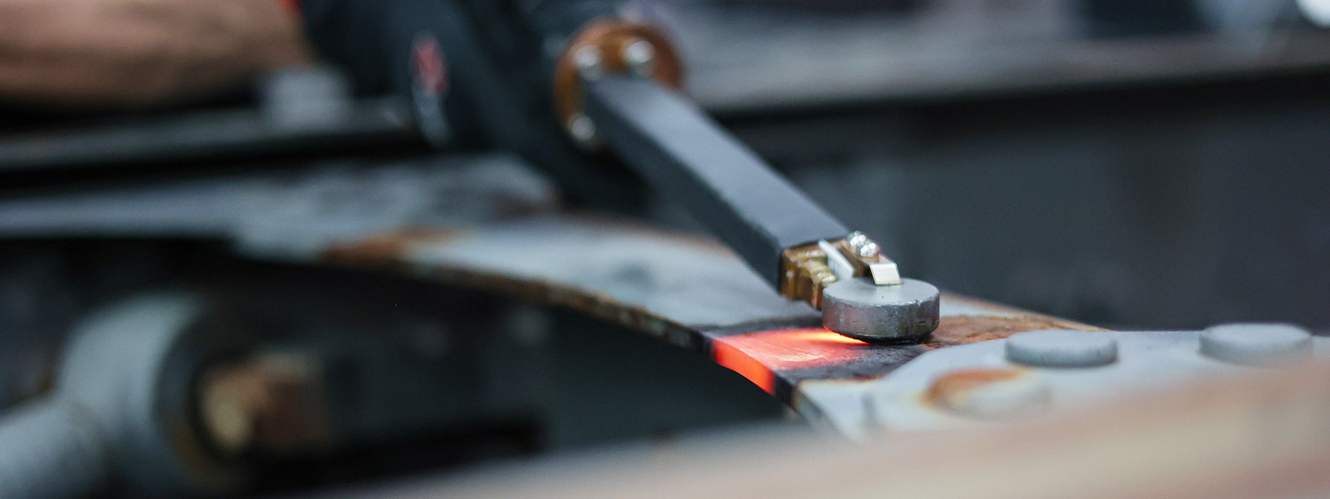 A technician using JOSAM JH400 induction heater to heat metal surface