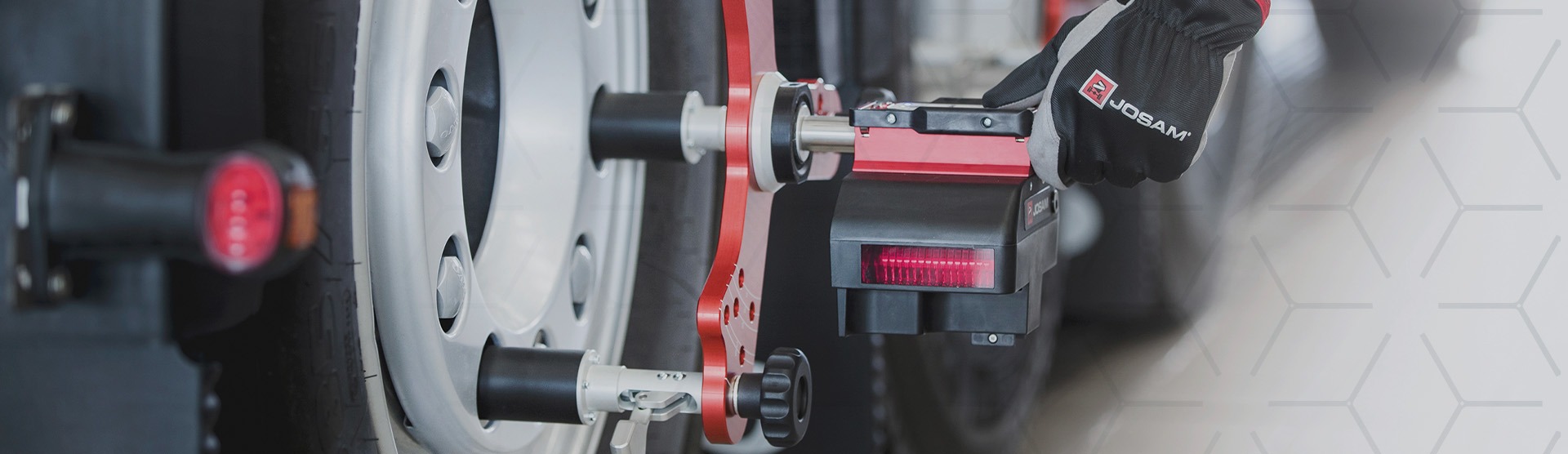Technician using JOSAM I-Track II to perform a wheel alignment