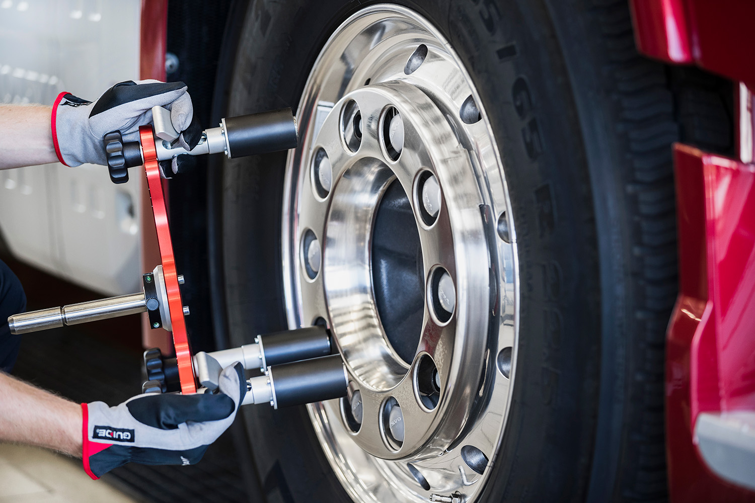 A technician attaching magnetic wheel clamp