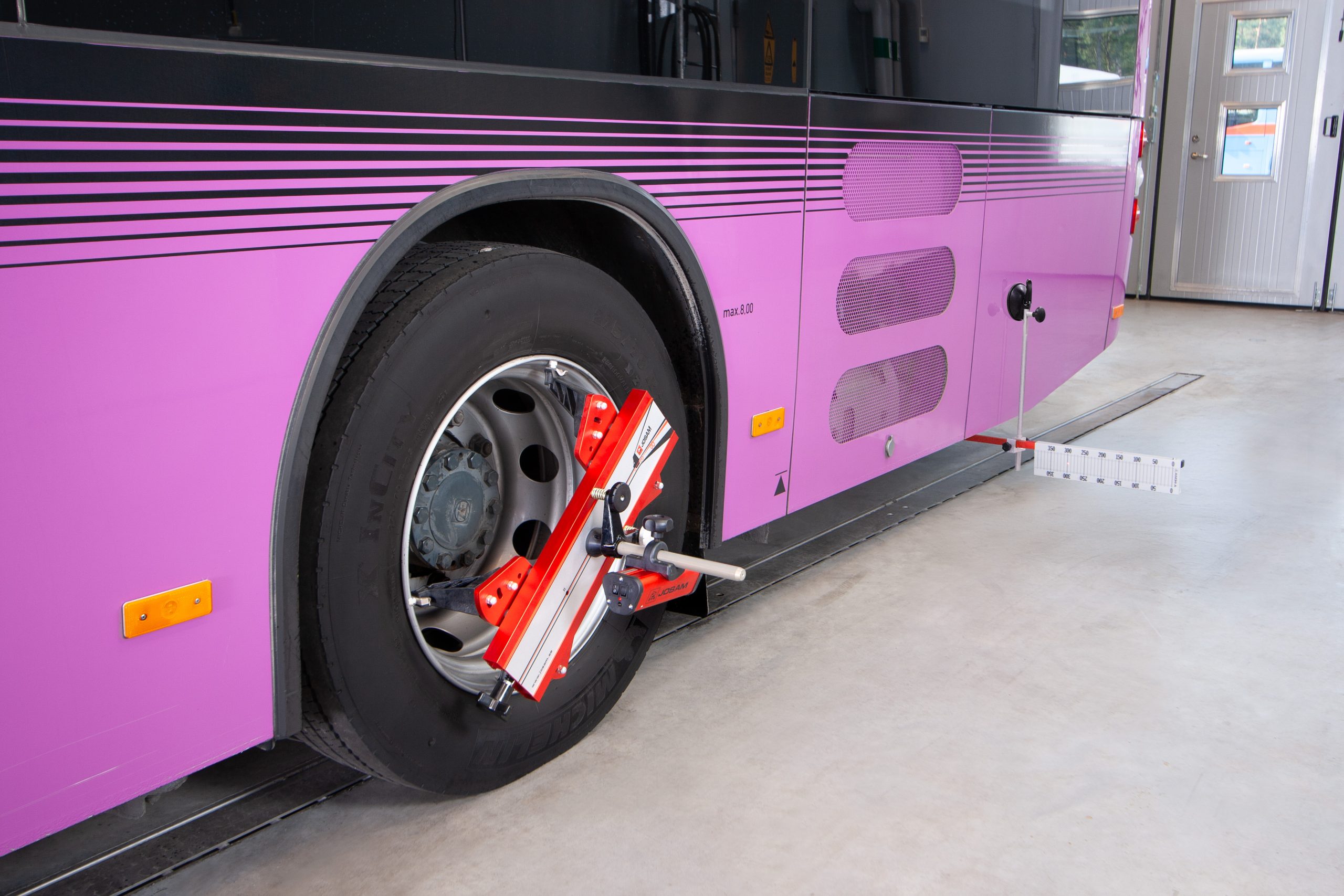 A bus with Josam Laser-AM wheel alignment system attached
