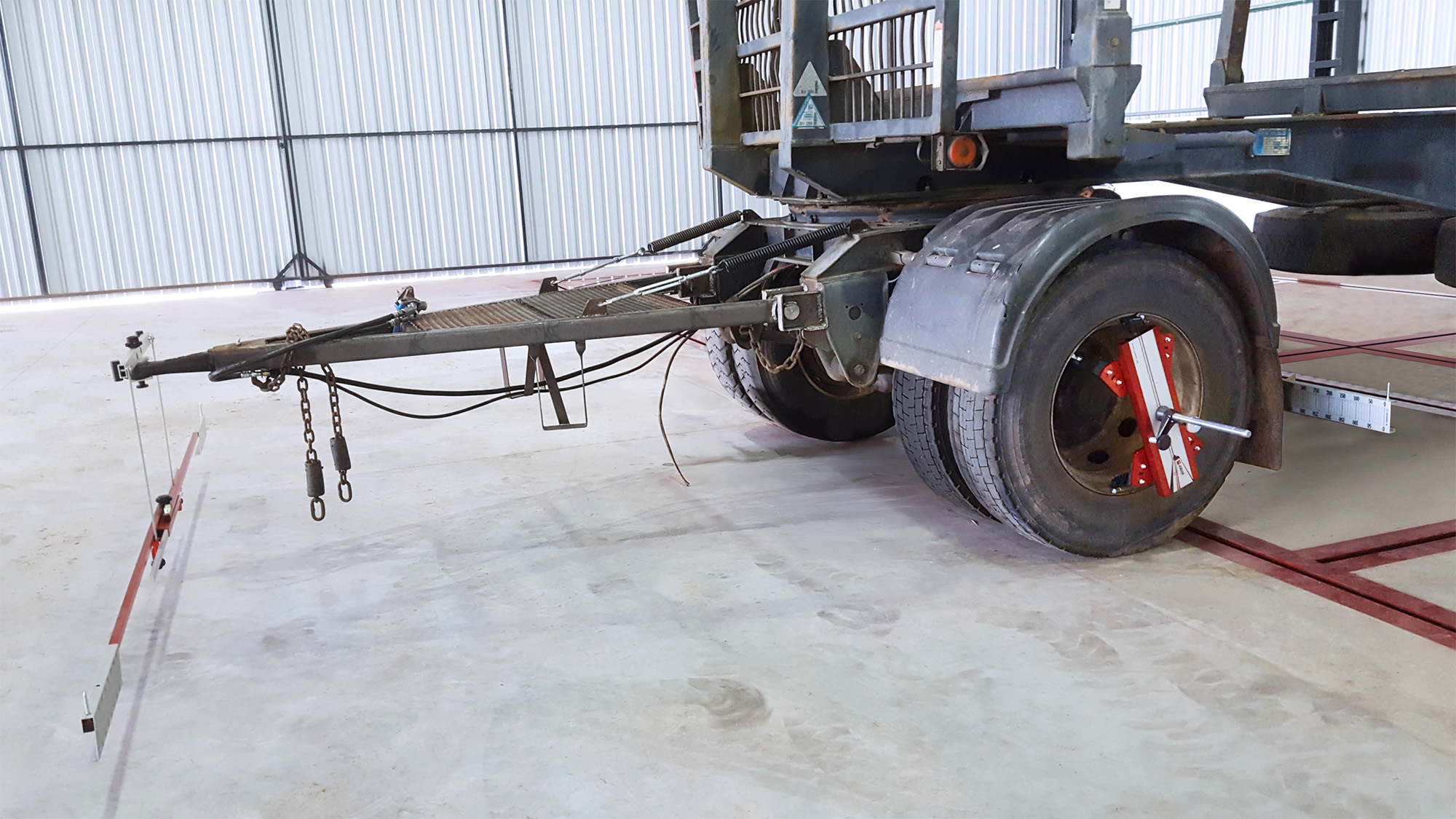 A trailer with Josam Laser-AM wheel alignment system attached