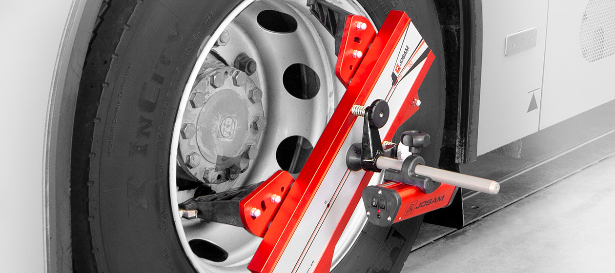 Laser AM wheel aligner attached to truck wheel