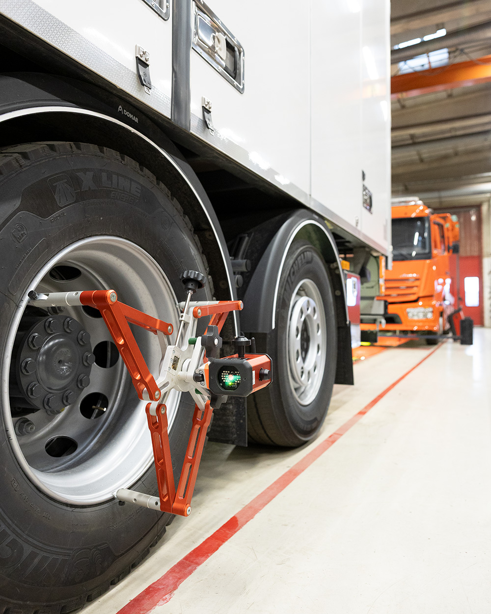 JOSAM Cam-Aligner being used to perform an alignment on a truck in a workshop