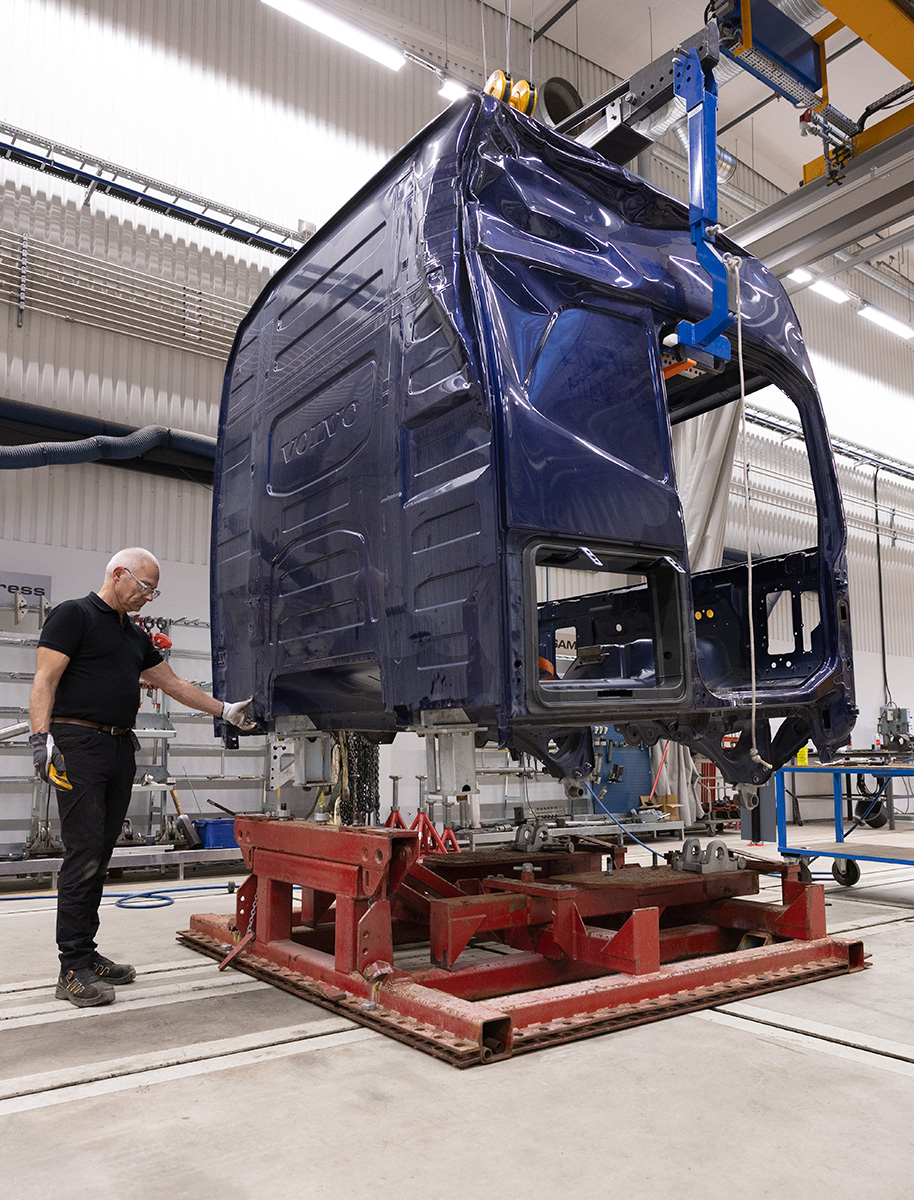 Technician working on a truck cab mounted on the JOSAM Cab Bench