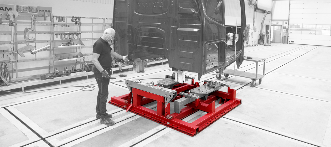 Technician mounting a truck cab on JOSAM Cab-Bench