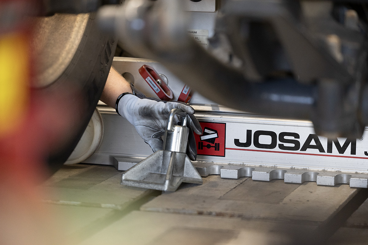 Technician securing JOSAM Frame Press trolley with floor mounts