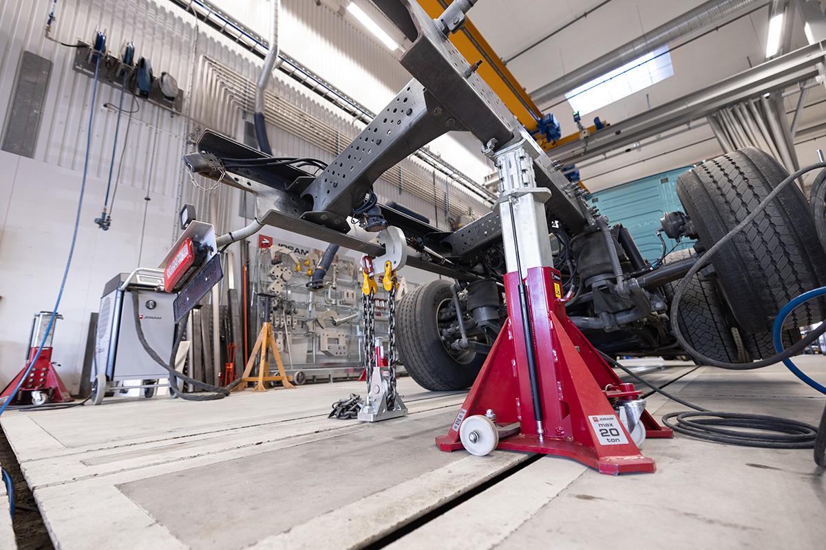 A truck frame being adjusted with the use of a JOSAM floor jack