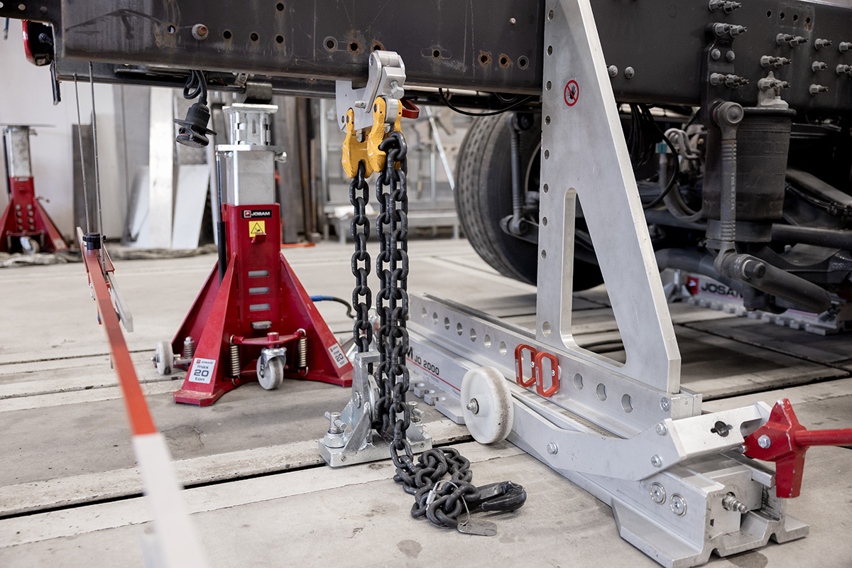 JOSAM floor jack, chain , and Frame Press trolley being used on truck frame