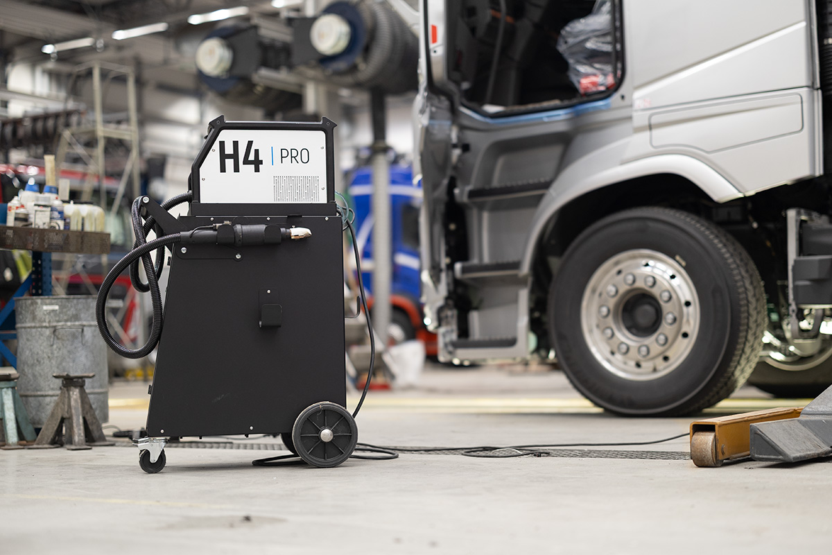 JOSAM H4 PRO induction heater in workshop environment with a truck in the background