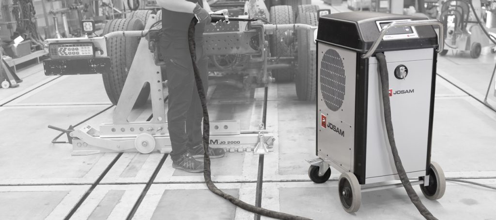 Technician using a JOSAM JH1500 induction heater in a workshop