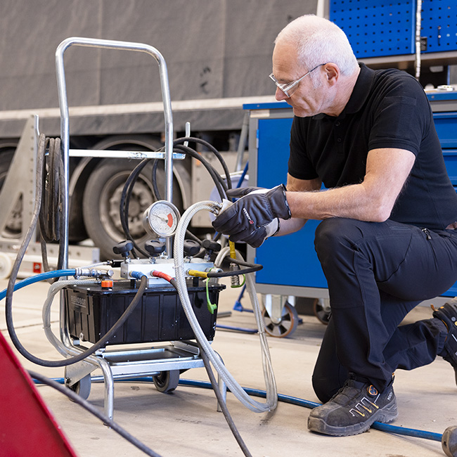 Technician working with a hydraulic pump