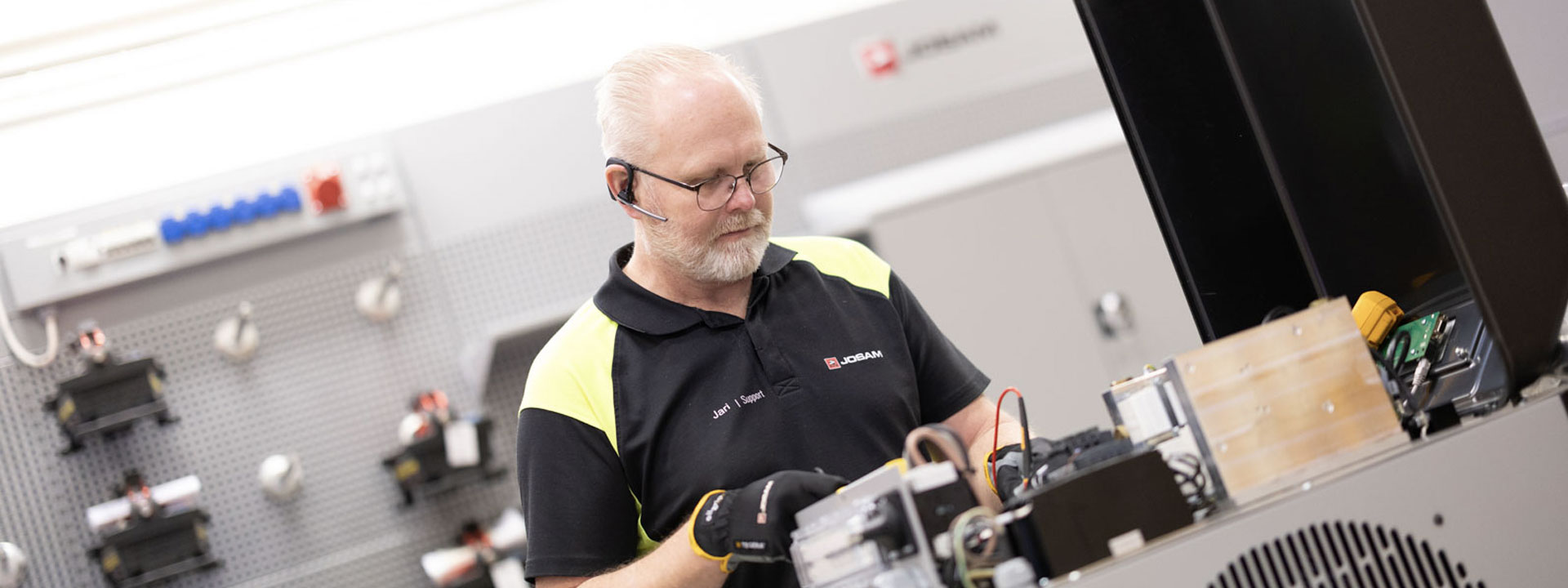 A JOSAM technician performs maintenance on an induction heater